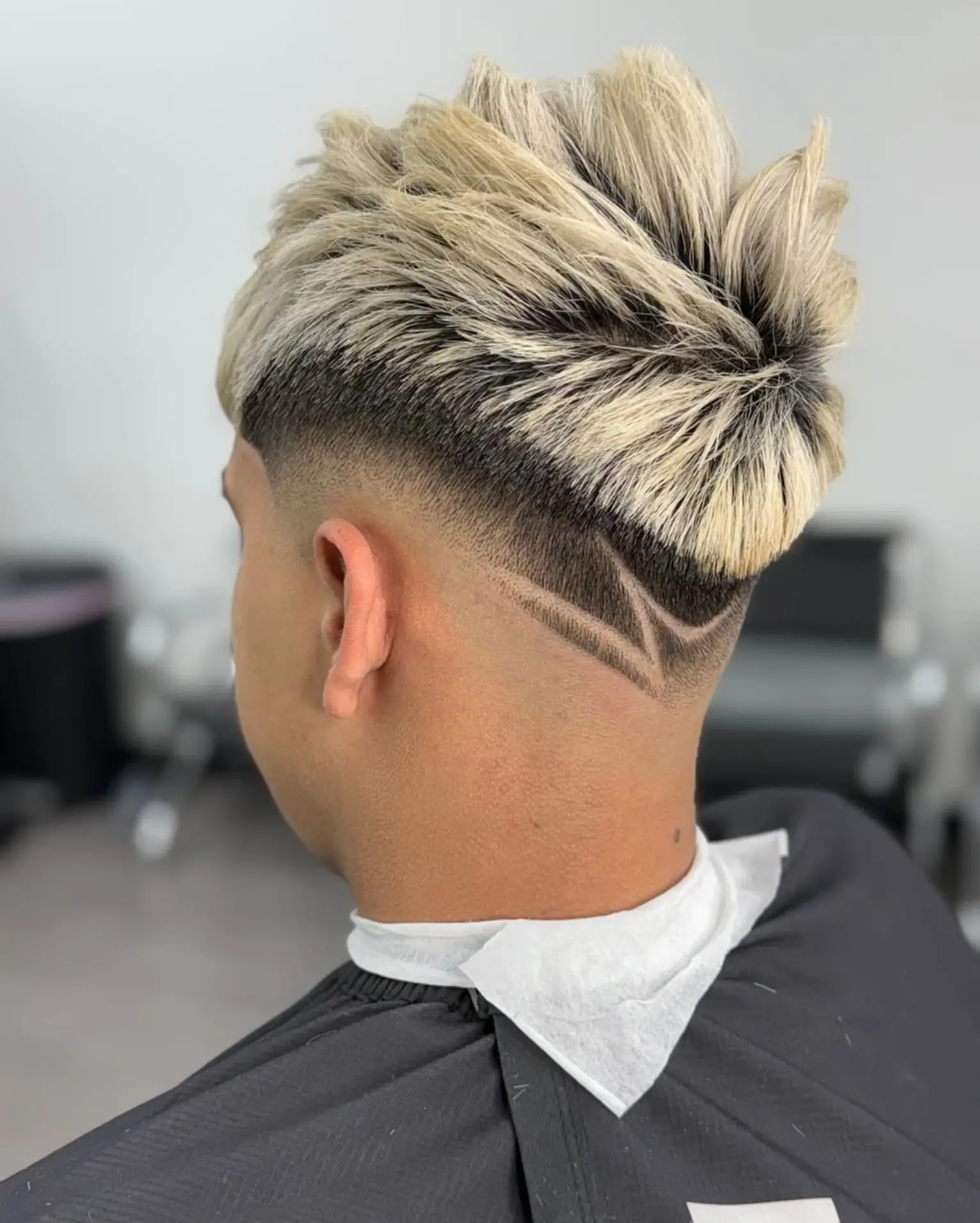 Black and white portrait of a textured mohawk fade